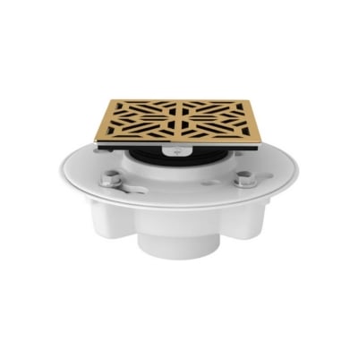 A white and gold drain cover with a decorative pattern.