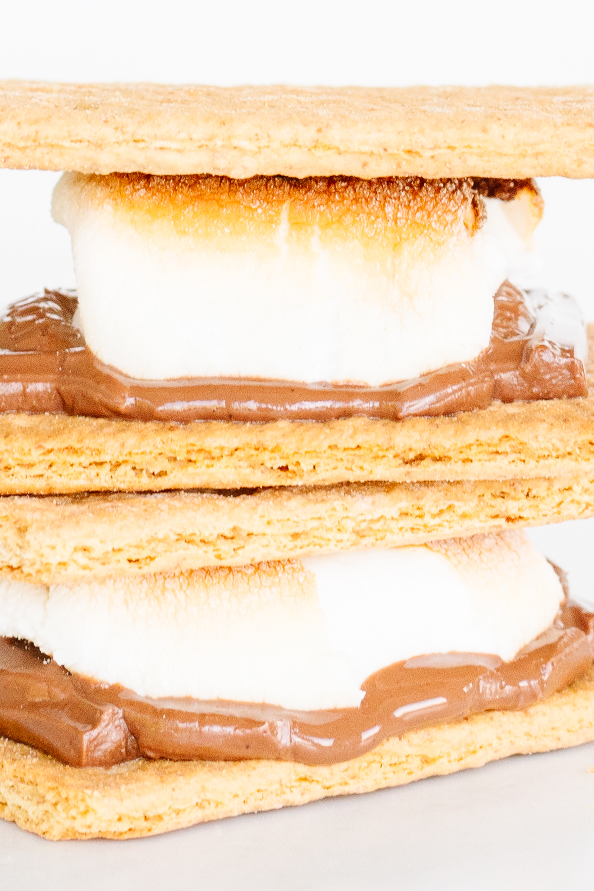 Three s'mores arranged in a vertical stack.