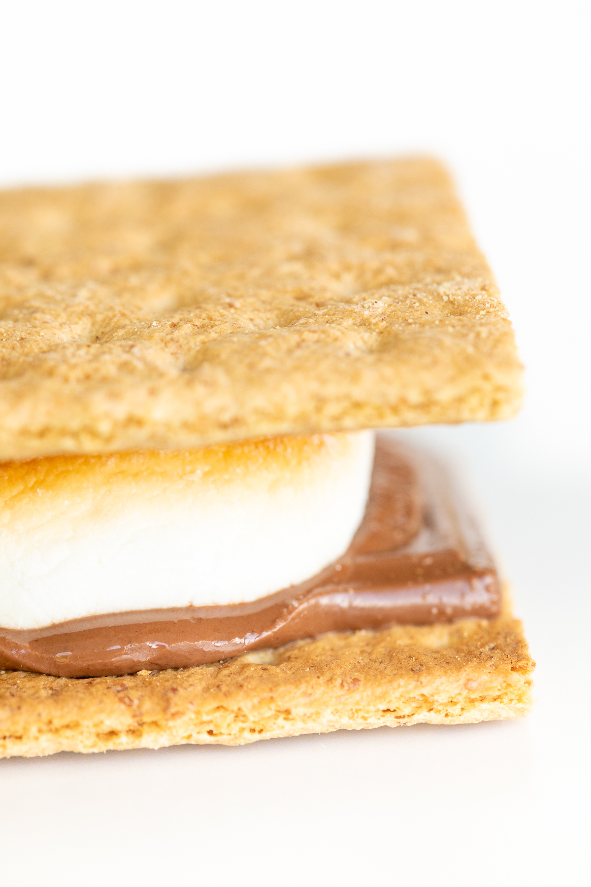 An oven-baked s'mores with graham cracker, chocolate, and marshmallow.
