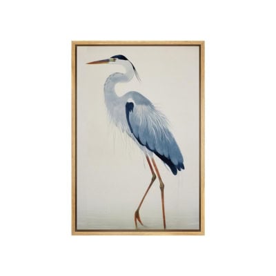Framed artwork of a blue and white heron with long legs and an orange beak, standing upright, offering a chic Pottery Barn look for less.
