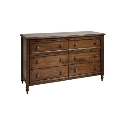A wooden dresser with six drawers, featuring round metal handles and decorative carved legs, offers a Pottery Barn look for less, shown against a plain background.