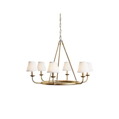 A brass six-arm chandelier with white fabric lampshades, offering a Pottery Barn look for less, suspended from a chain.