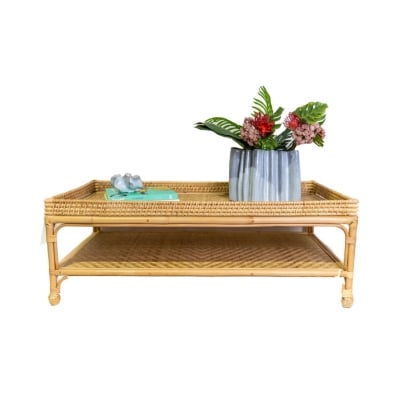 A rattan tray with a vase of flowers on it, perfect for serena and lily dupes enthusiasts.