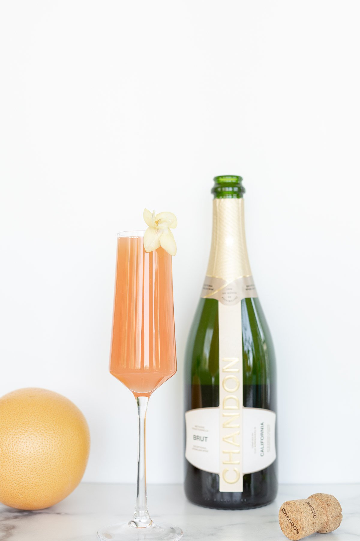 A glass of champagne next to a bottle of orange juice, perfect for Amazon gadgets enthusiasts.
