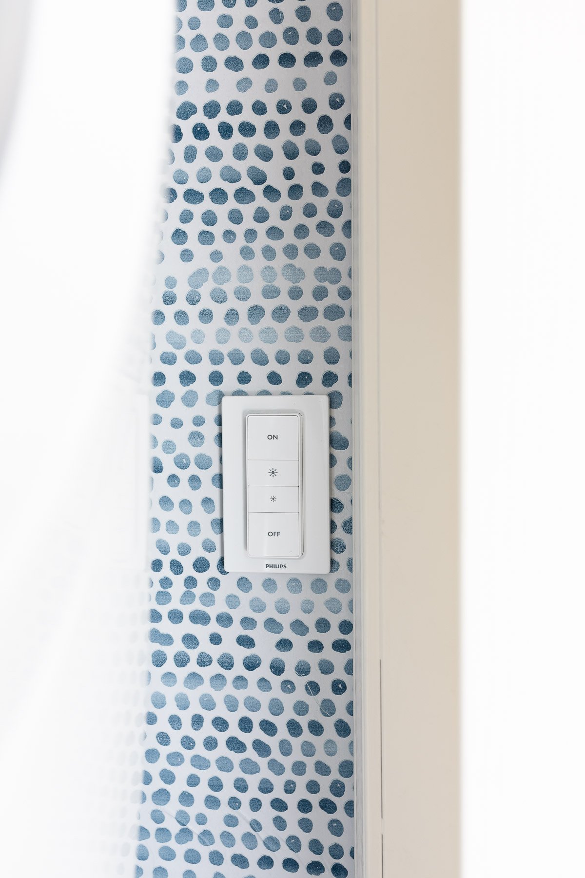 A light switch with a blue and white polka dot pattern available on Amazon.