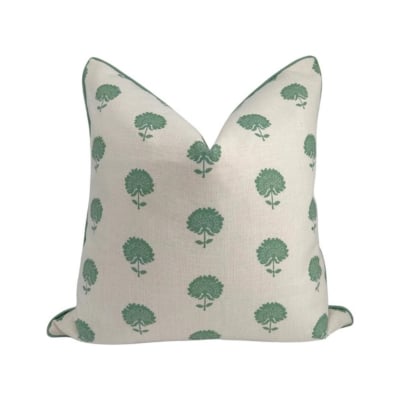 A floral-patterned pillow in green and white, available on Amazon.