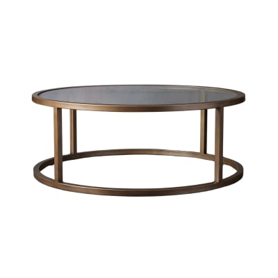 A brass-framed coffee table with a glass top, offering an affordable alternative to the Arhaus look.