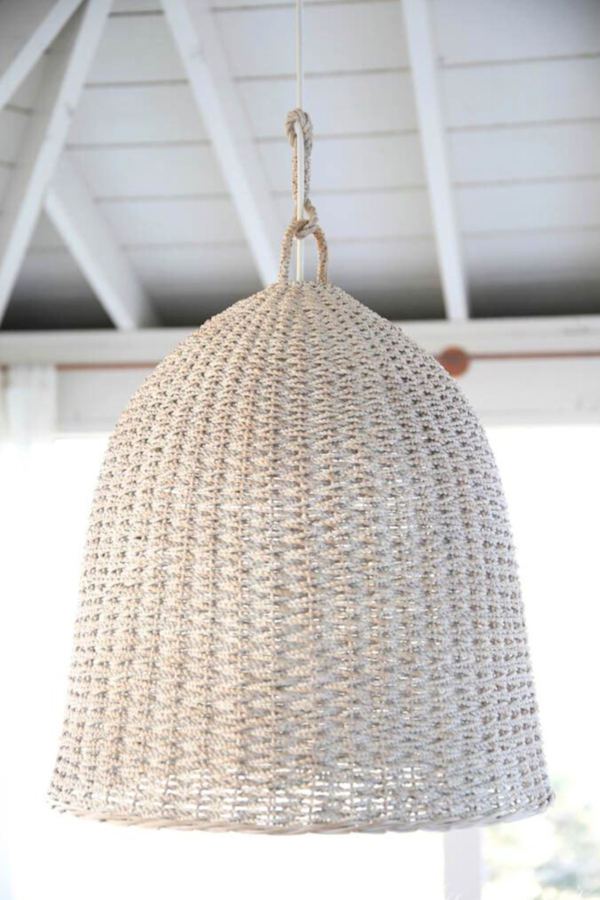 A white basket pendant light hangs on the porch.