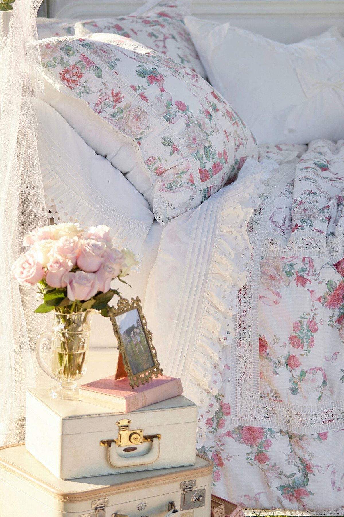 A bed with a floral comforter and a vase of flowers, perfect for a tween bedroom.