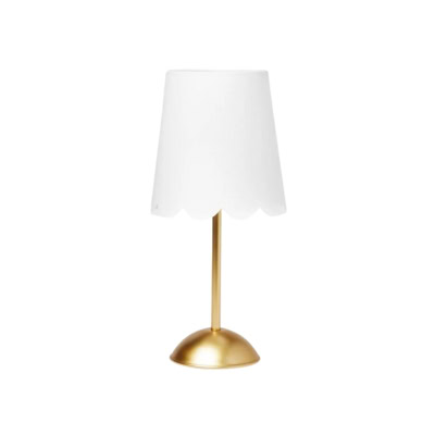 A table lamp with a white scalloped lampshade and a gold base and stand, offering a chic Pottery Barn Kids look for less.