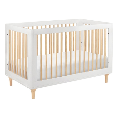A white convertible crib with wooden slats.