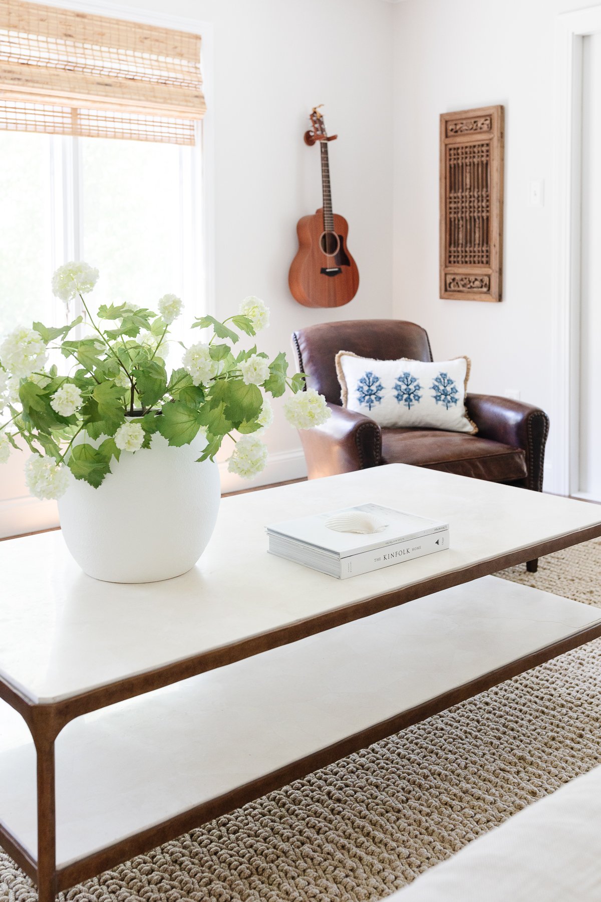 A white coffee table with a plant on it, perfect for achieving the Serena and Lily look for less.