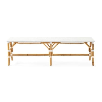 A white rattan bench inspired by the Serena and Lily look for less, set against a white background.