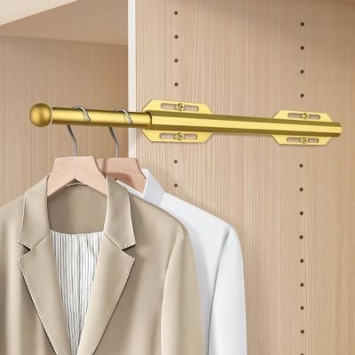 Gold pull-out clothes rod with hangers holding a beige blazer and a white shirt, mounted inside a light wood closet—an elegant space-saving solution inspired by some of the best amazon gadgets for wardrobe organization.