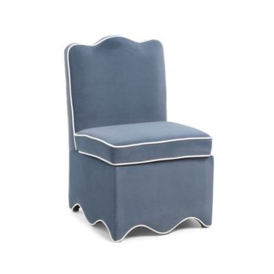 Blue upholstered chair with a skirted base and white piping along the edges, featuring a wavy trim at the bottom and a slightly curved backrest—a charming addition to any room with an eye for scalloped decor.
