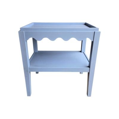 A light blue wooden side table with scalloped decor along the apron, one lower shelf, and four straight legs.