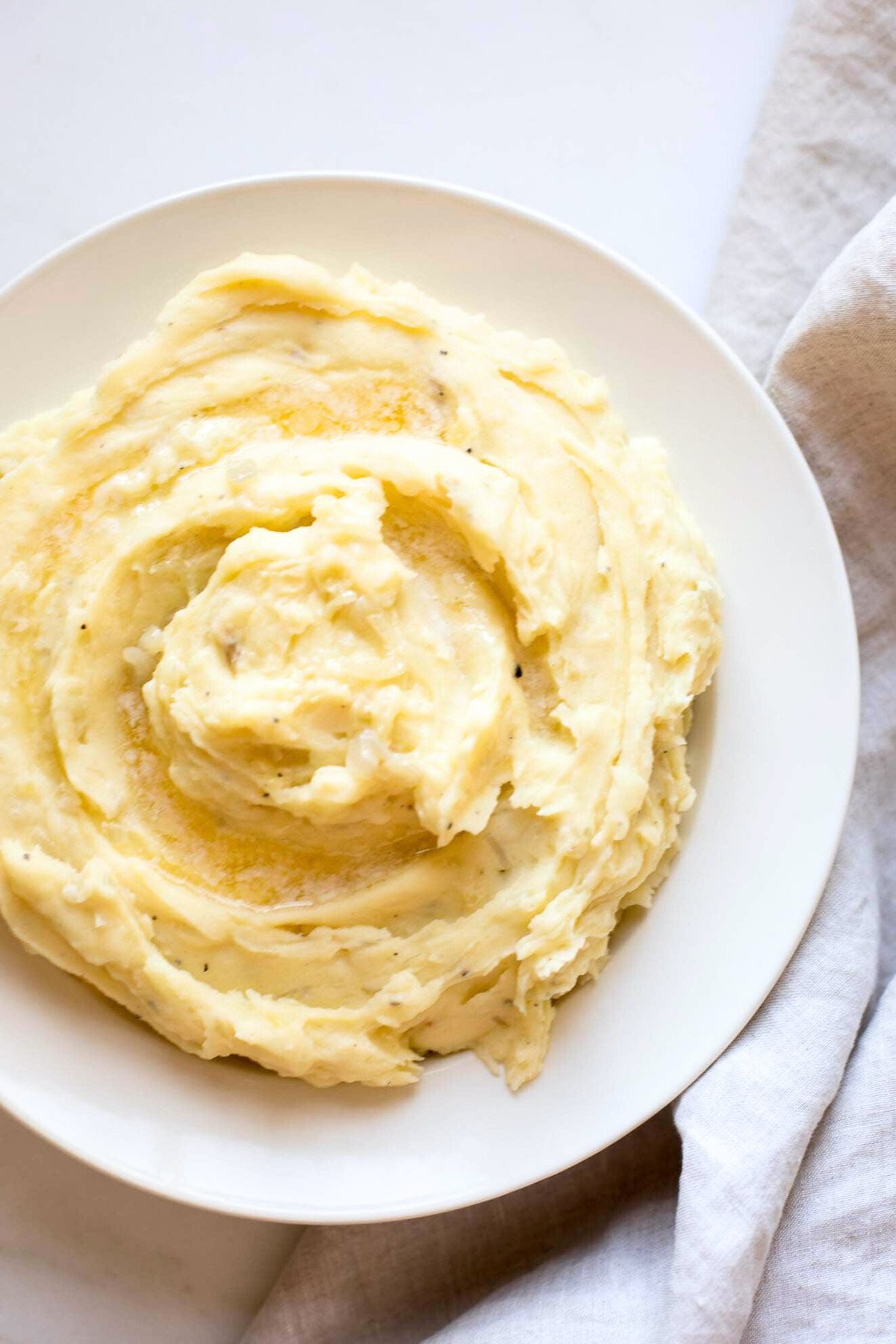 Caramelized shallot mashed potatoes in a white bowl. 