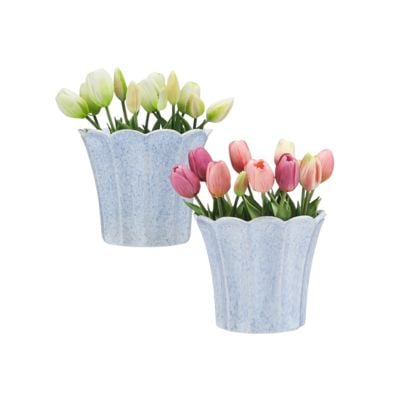 Two light blue, scalloped-edge pots add charming scalloped decor to any space, each containing artificial tulips—one with pale yellow blooms, the other with pink and red flowers.