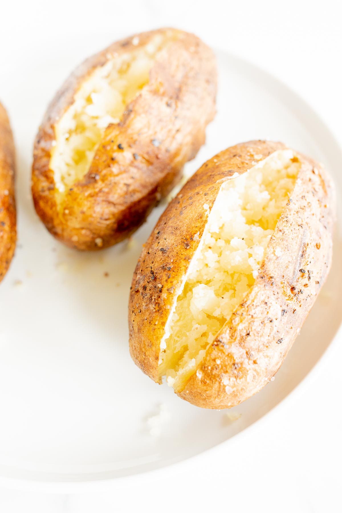 grilled baked potatoes on a white plate