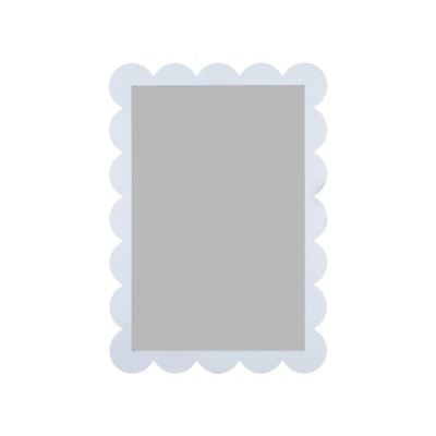 A rectangular mirror with a white scalloped-edge frame adds a touch of scalloped decor against a plain white background.