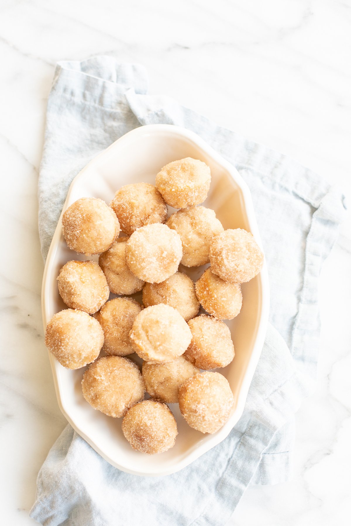 Cinnamon sugar donuts in a white bowl for Mother's Day brunch.
