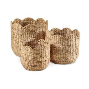 Three woven baskets with scalloped edges, displayed nested together in varying sizes, make charming scalloped decor for any room.