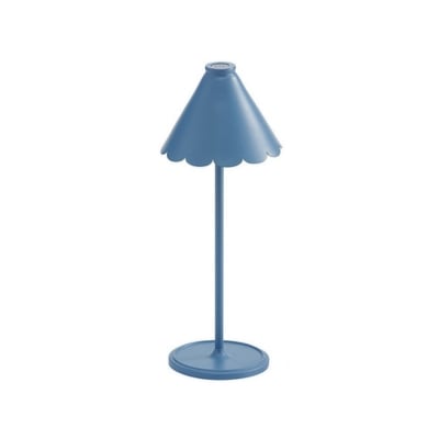 A small table lamp with a scalloped blue shade.