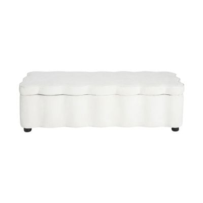 A white bench with a white cushion features delicate scalloped decor for a charming, elegant touch.
