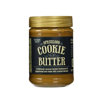 A jar of Trader Joe's Speculoos cookie butter on a white background. The label describes it as a gingerbread-flavored spread made from crushed biscuits, perfect for various cookie butter recipes.