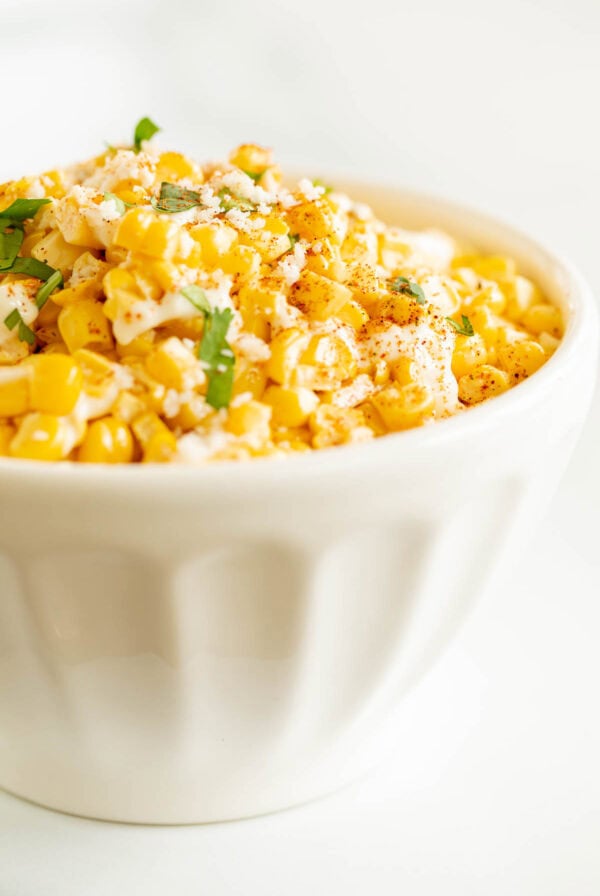 A bowl of Mexican street corn salad in a collection of pulled pork side dish recipes.