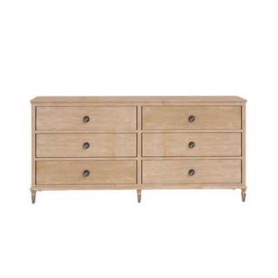 A wooden dresser with six drawers featuring round metal knobs, evenly arranged in two rows of three, offering a Pottery Barn look for less.