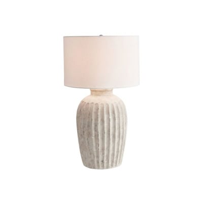 A white ceramic table lamp with a ribbed base and a plain white cylindrical lampshade, offering a chic pottery barn look for less.