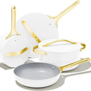 This elegant set of white cookware with gold handles, including a saucepan, Dutch oven, and frying pan, is perfectly arranged against a white background. Discover this luxurious kitchen essential during Prime Day for the ultimate culinary upgrade.