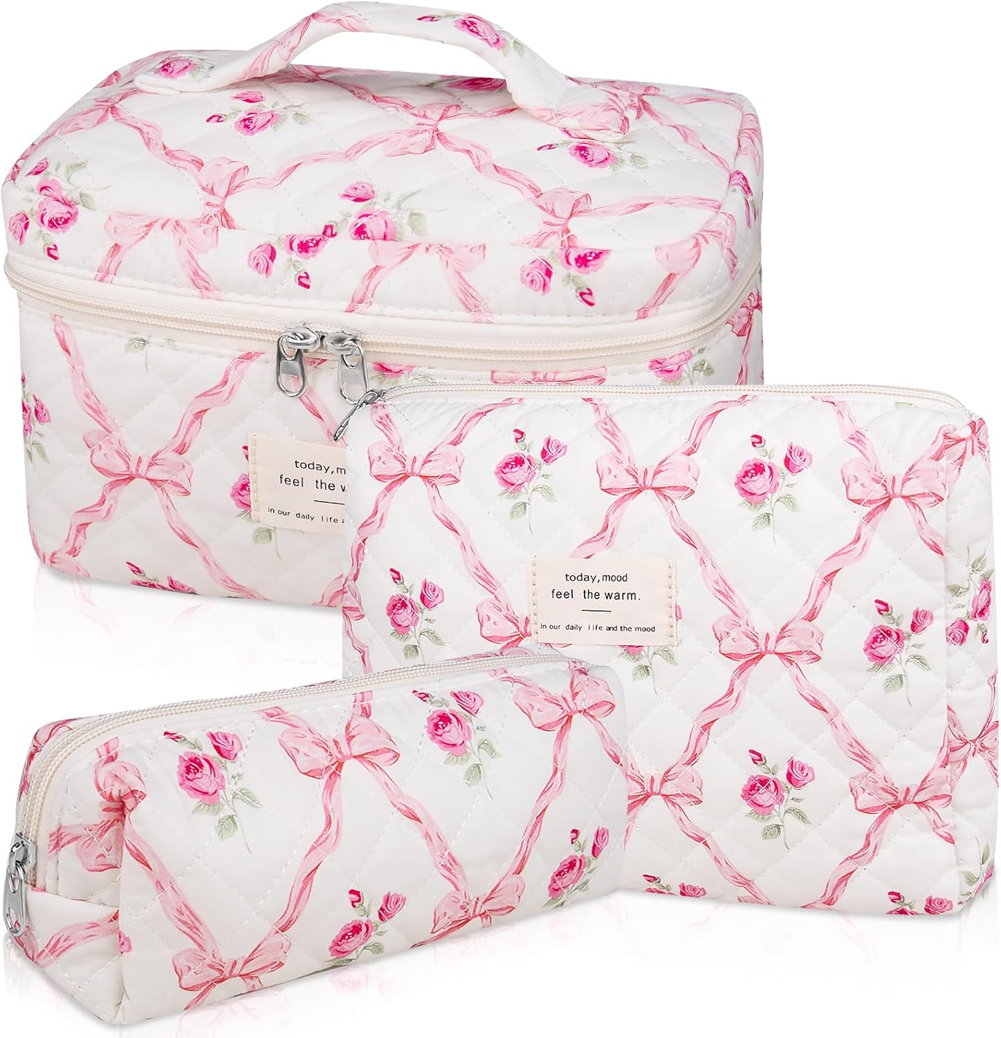 Three floral-patterned bags adorned with pink bows are perfect for Prime Day shopping. The largest features a handle and zipper, while the medium and small are convenient zippered pouches, all in varying sizes to suit your needs.