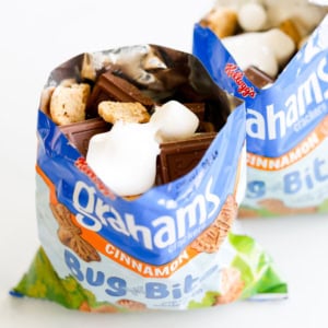 An open bag of graham crackers with chocolate and marshmallows inside for walking smores.