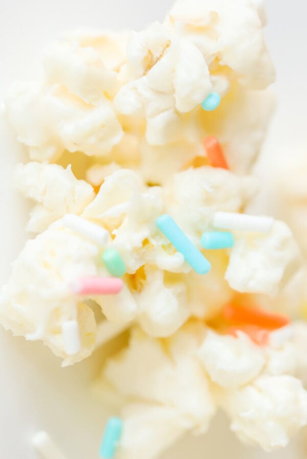 Close-up of Birthday Cake Popcorn, featuring popcorn coated in white chocolate and sprinkled with colorful toppings.