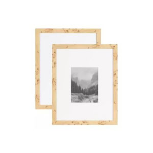 Two light wood picture frames, each displaying a black and white landscape photo with mountains and trees, evoke a Pottery Barn look for less against a plain white background.