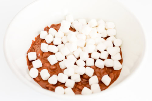 A bowl of chocolate pudding topped with mini marshmallows offers a delightful twist reminiscent of Rocky Road candy.