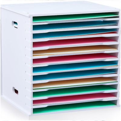 A white, cubed organizer with multiple horizontal shelves stands ready for organizing crafts, each tier neatly holding papers of various vibrant colors.