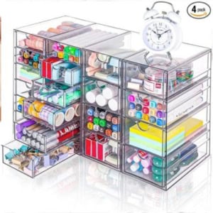 This clear plastic organizer with drawers is perfect for keeping your stationery and organizing crafts. It holds pens, tapes, sticky notes, and even an alarm clock all in one place.