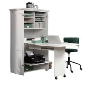 This white cabinet-style desk, perfect for craft space ideas, features open shelves, storage boxes, and a pull-out table on wheels. A green office chair complements the setup for a functional and inspiring workspace.