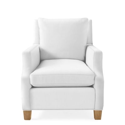 Charming white upholstered armchair with wooden legs, offering a cushioned backrest and seat for a Serena and Lily look for less.