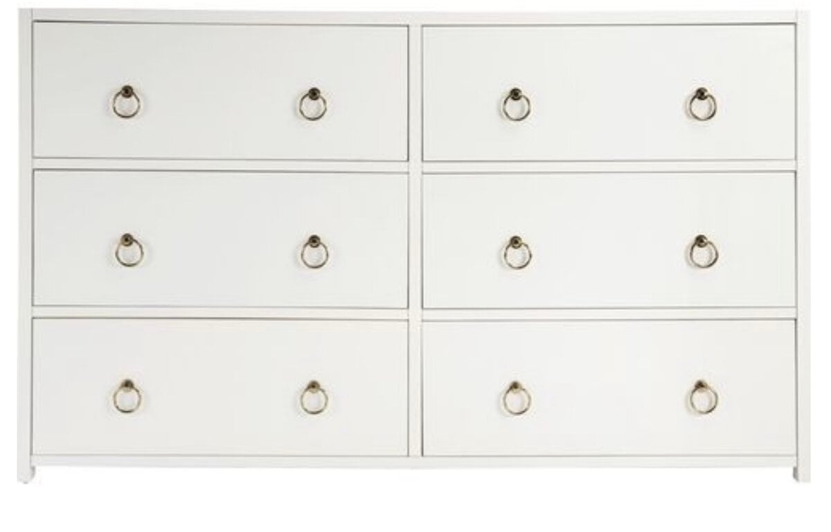 This white six-drawer dresser, featuring elegant metal pull handles and arranged in two rows of three, offers a Serena and Lily look for less, bringing both style and functionality to your space.