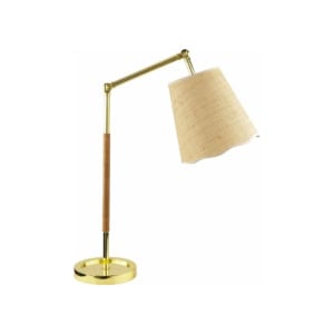 A gold desk lamp with a round base, adjustable arm, and beige fabric lampshade brings a Serena and Lily look for less. The arm is partially wrapped with a textured material for added style.
