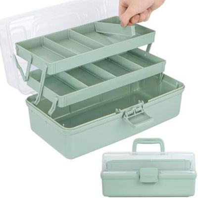 A light green plastic toolbox with a clear lid and three-tiered compartments being opened, perfect for organizing crafts. A hand is lifting the top tray.