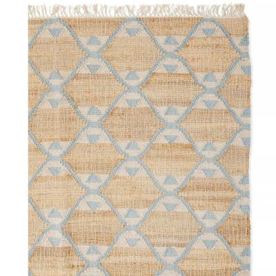 A beige jute rug featuring a blue geometric diamond pattern and fringed edges on one side, perfect for adding texture. Refer to our rug size guide to select the ideal fit for your space.