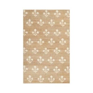 Beige rectangular rug with a repeating pattern of white, stylized floral motifs evenly spaced across the surface. Refer to our rug size guide to find the perfect rug size for your space.
