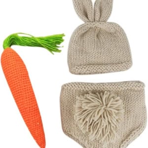 This charming knitted baby outfit, perfect as Easter basket fillers, features a beige hat with bunny ears, a matching diaper cover with a fluffy tail, and an adorable orange carrot toy with a green top.