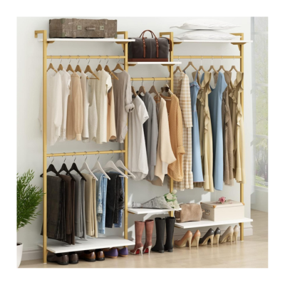 Open kids closet with hanging clothes, folded linens, shoes, and bags neatly arranged.