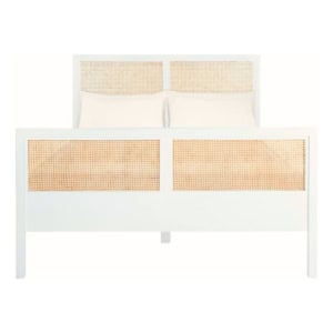 A white wooden bed frame with woven rattan panels on the headboard and footboard, shown with two white pillows—perfect for achieving a Serena and Lily look for less.